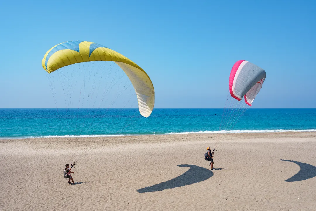paraglider-tandem-flying-sea-shore-with-blue-water-sky-horison-view-paraglider-blue-lagoon-turkey